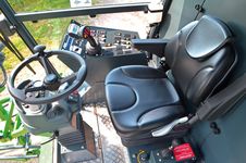 The comfortable working environment in the spacious cab features clearly laid-out and ergonomic controls, including a multi-function joystick. From his air-sprung seat the driver has a clear view on all the front attachments.